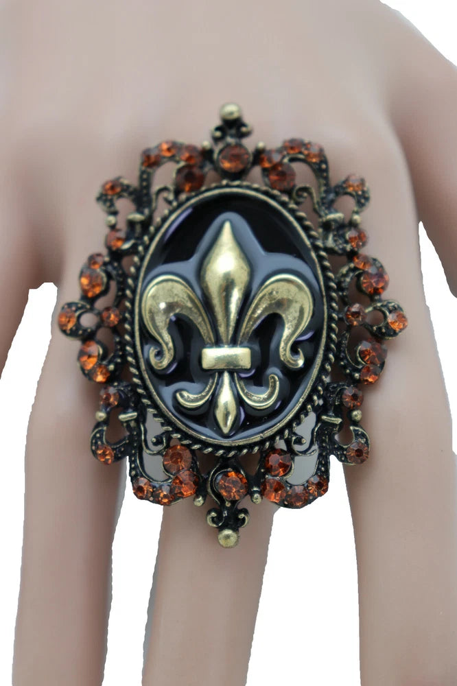 Gold-tone fleur de lys statement ring, dark enamel, orange stones