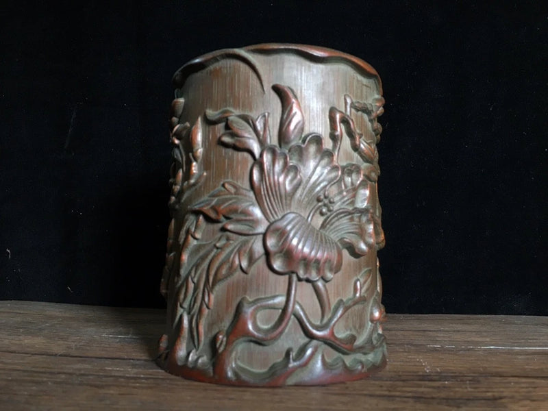 Carved bamboo brush pot with relief peony flower pattern, cylindrical dark bronze