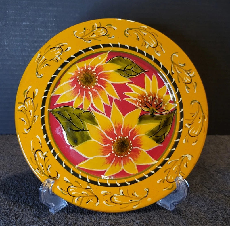Hand-painted terracotta salad plate with yellow floral border and center flowers, on stand