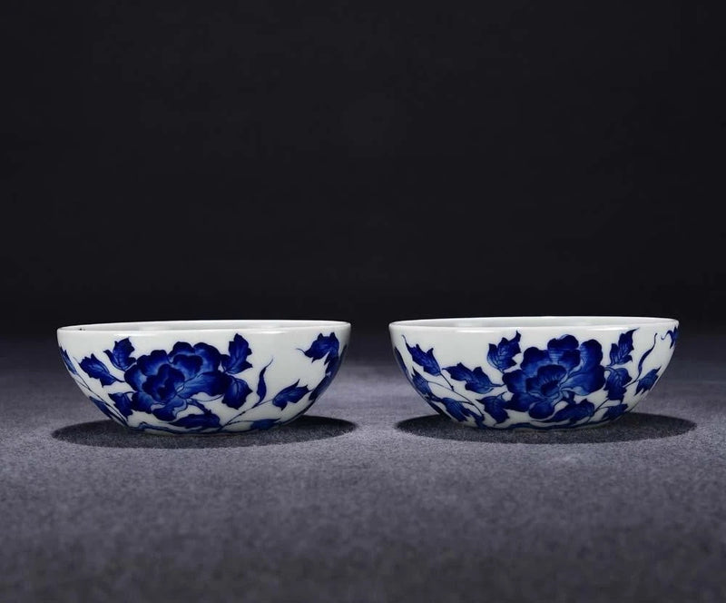 Pair of blue-and-white porcelain cups with peony floral design