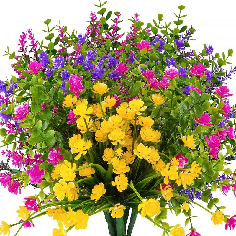 Artificial faux flower bouquet with green leaves, yellow, pink, and purple blossoms