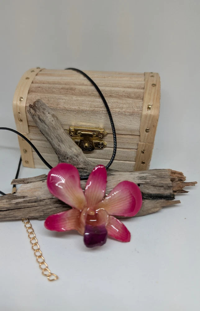 Pink orchid resin hair clip with black faux leather necklace and gold chain