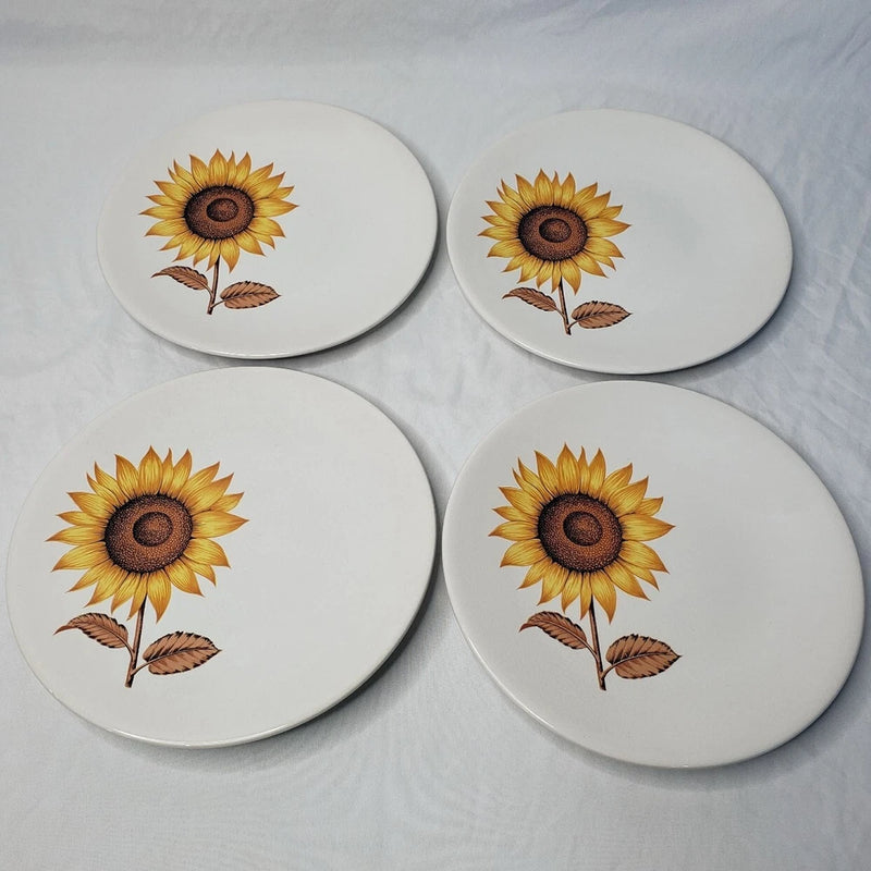 Set of four white ironstone dinner plates with sunflower and leaf design