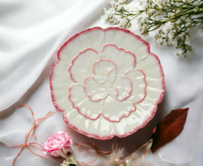 Ceramic carnation plate with white base, red scalloped rim, raised flower design