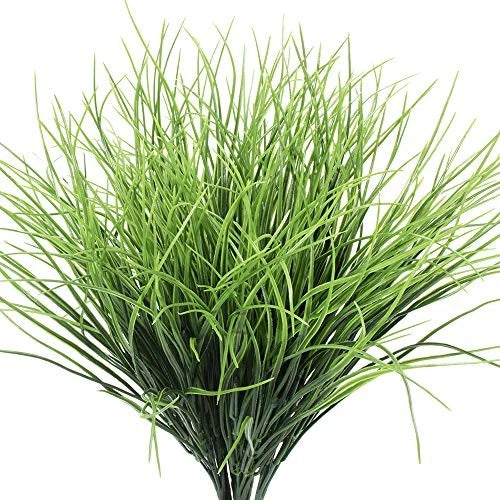 Artificial wheat grass plant with dense green blades in a bundle