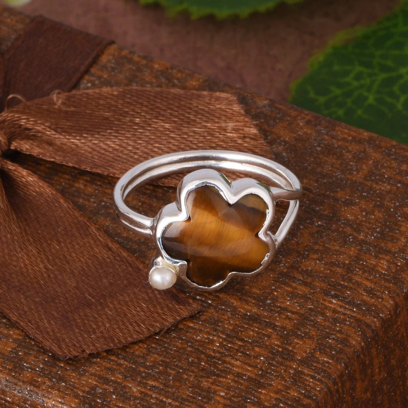 Silver-tone tiger eye gemstone ring with clover-style setting and small pearl