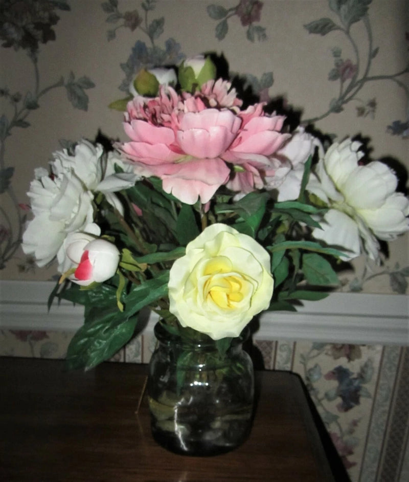 Silk peony flower arrangement with pink and white blooms in clear glass vase