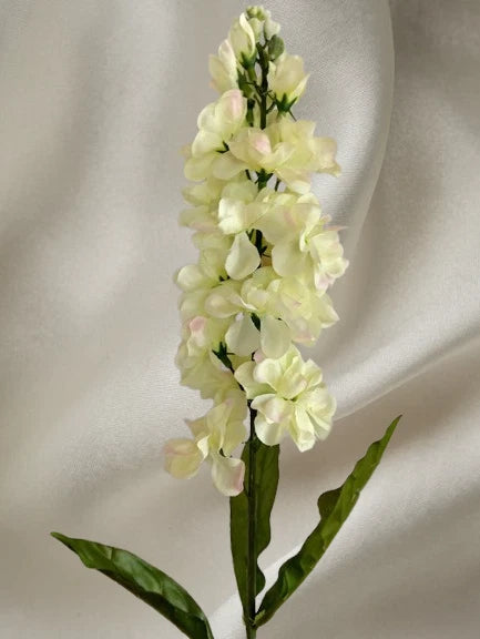 Artificial stock flower stems with pale cream blooms and green leaves