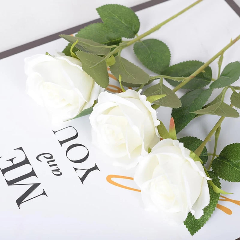 White faux silk roses with green leaves and stems, bundle of flower heads